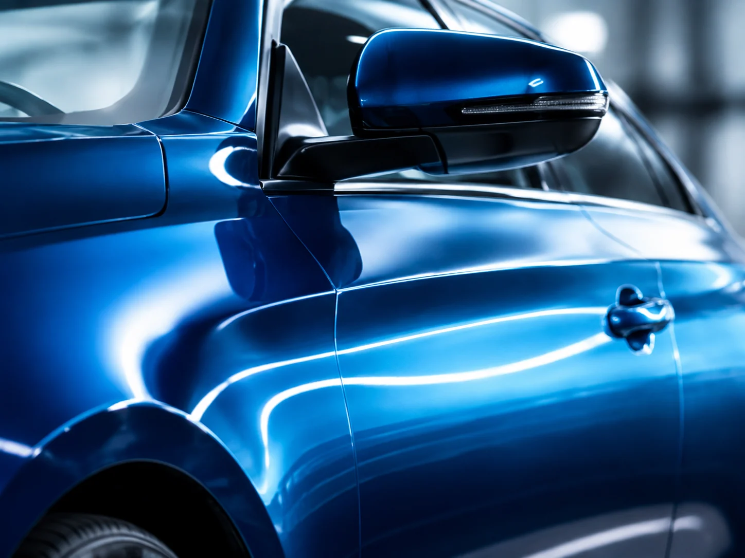 Glossy blue automotive coating on a vehicle panel