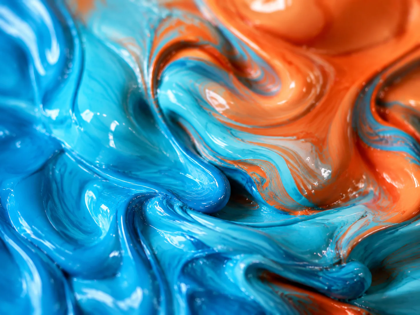 Cyan and orange pigments mixing into a smooth liquid